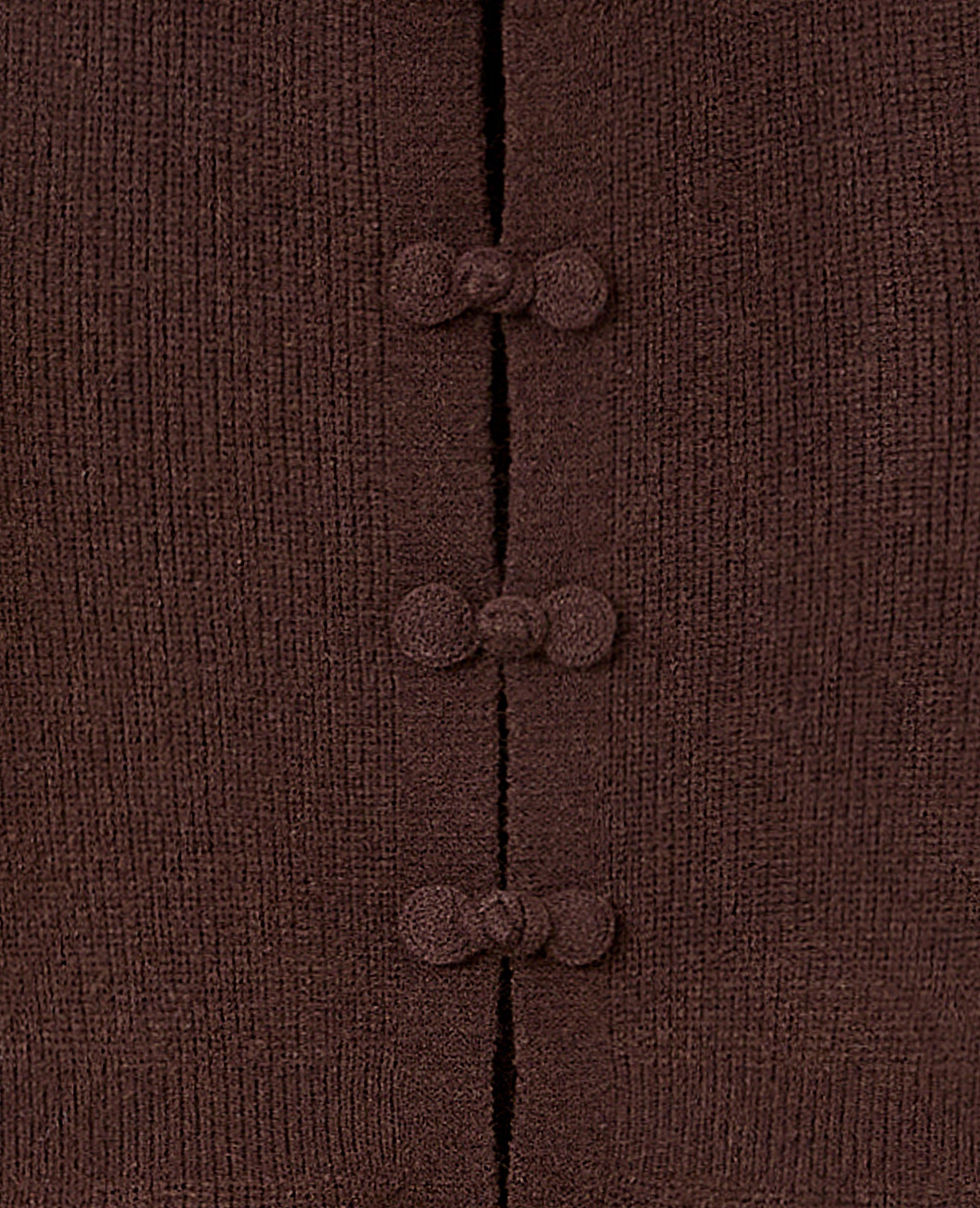 Gilet peplum avec boutons brandebourg