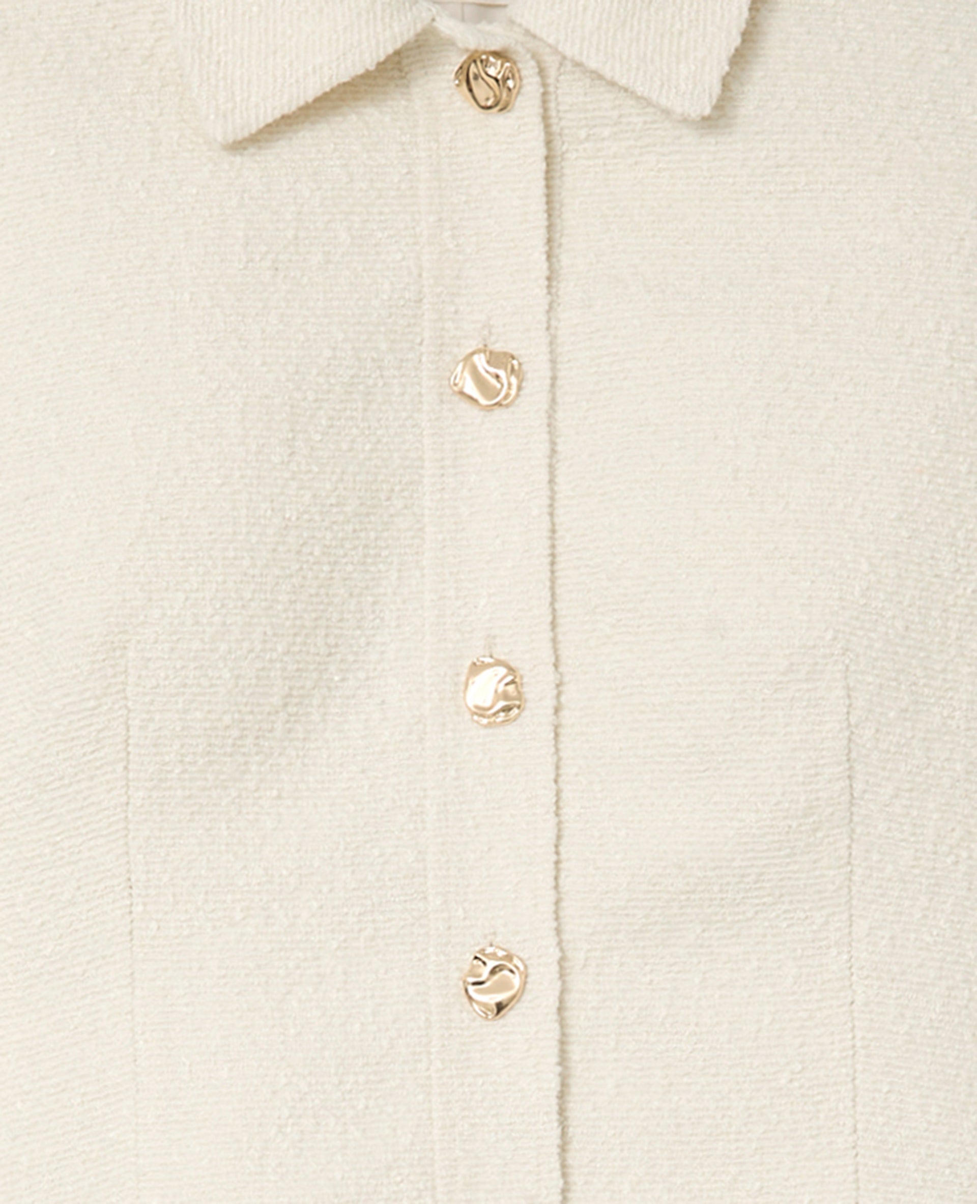 Veste cintrée en tweed avec boutons bijoux