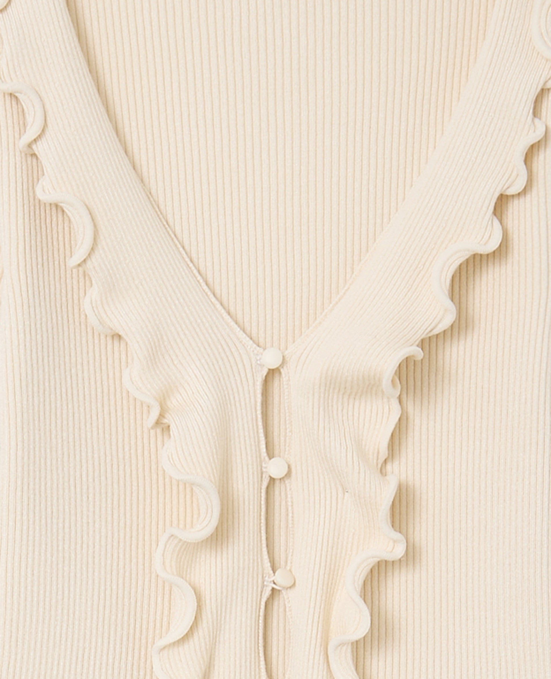 Gilet maille côtelée avec volants et bords ondulés